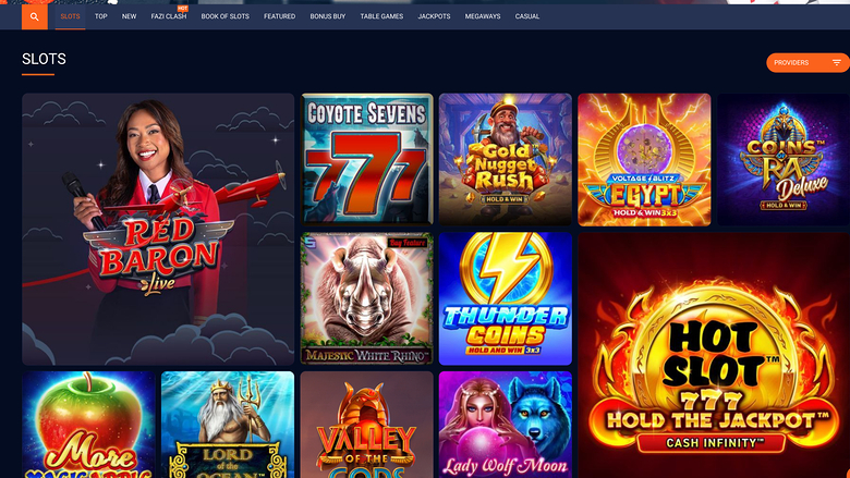 A casino lobby 'SLOTS' page showing a grid of game tiles beneath a top navigation bar.