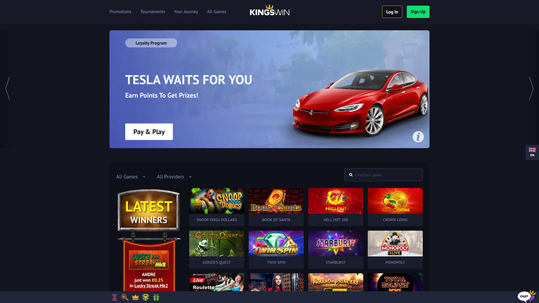 {"summary":"A King's Win online casino homepage showing a Tesla-themed loyalty promotion banner above a grid of game tiles.","colours":"Dark navy background wit