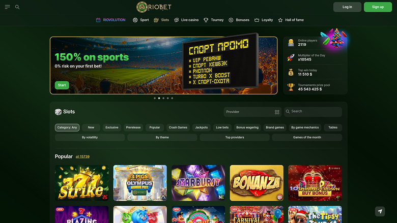 A RioBet online casino homepage showing a sports bonus hero banner, a slots lobby with filter controls, and a grid of game tiles.